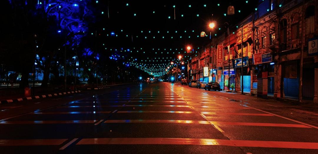 city street with lights turned on during night time