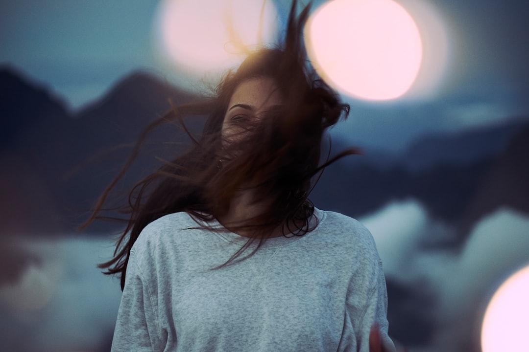 We were on our way to Maïdo in Reunion Island, it was 5:30 pm in the sunset. 
we were beyond the clouds at 2300 m altitude between mountains and volcanoes when I captured this unique moment. The hair of my model was caught in a cold and pure wind.