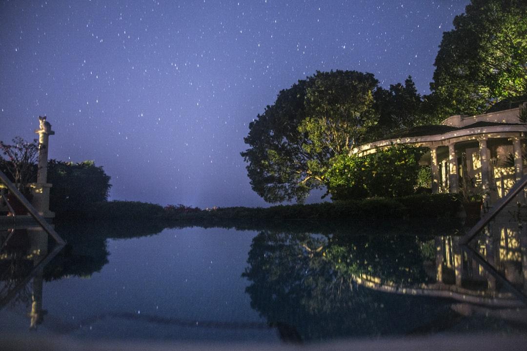 Visiting with a friend in Barbados when there was a power cut in his backyard. Managed to make a makeshift tripod and capture the stars over his pool.
