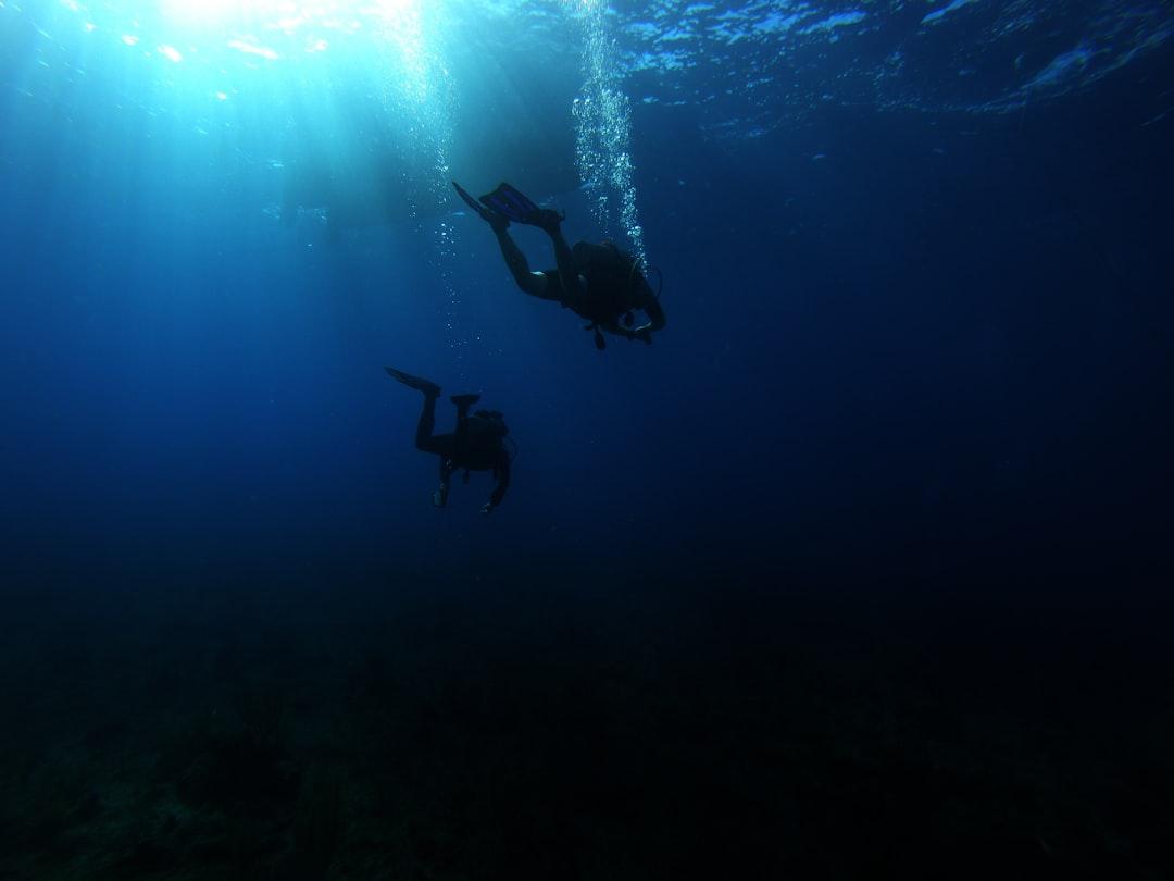 This photo is taken during the final dive of my dive certification course. It was taken near the North Wall dive site in Grand Cayman. There is a reef at approximately 50 feet depth which drops off to 8,000 feet. You can hover over the transfer staring into a dark abyss that seemingly has no end.