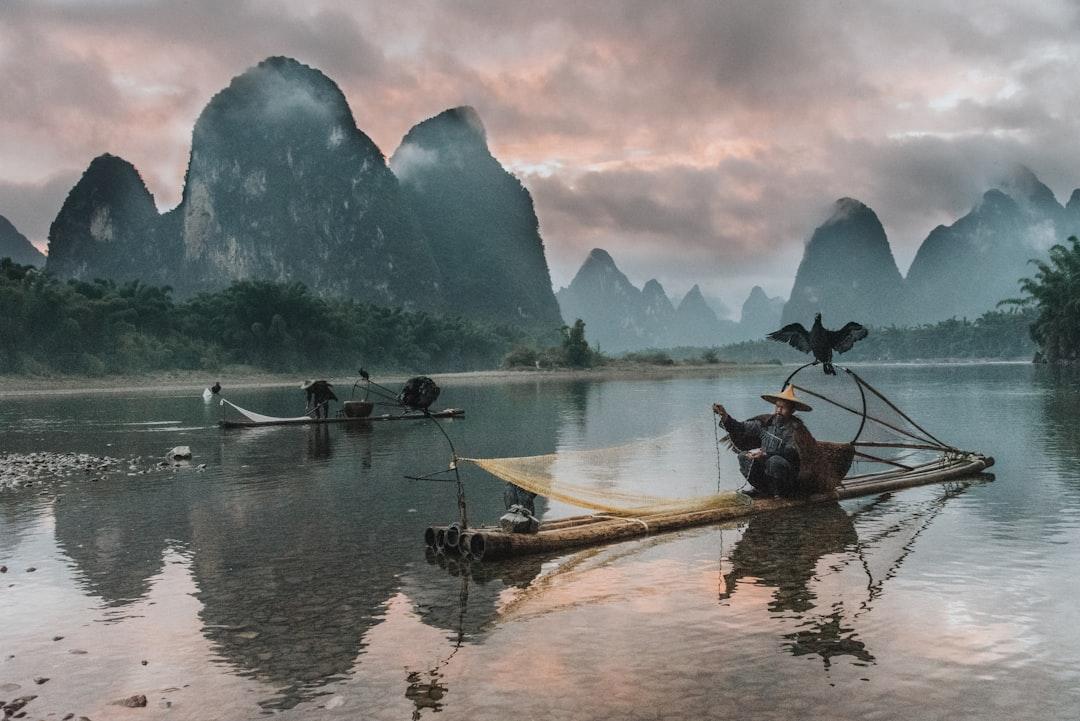 Sunset on the Li River as the few remaining cormorant fisherman pack their nets for the night.