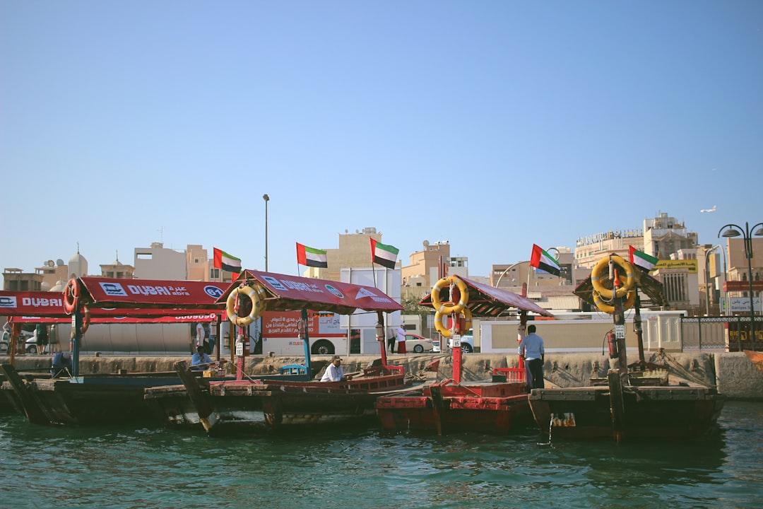 assorted-color boats near buildings during daytime