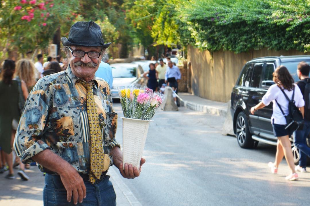 He stands there, on the streets of Byblos, with his cheerful smile and big heart. 
He will sing Lebanese love songs and crack jokes until a gentleman buys a flower for his lady friend. You can't see this face and not smile, we need more people like him in the world.