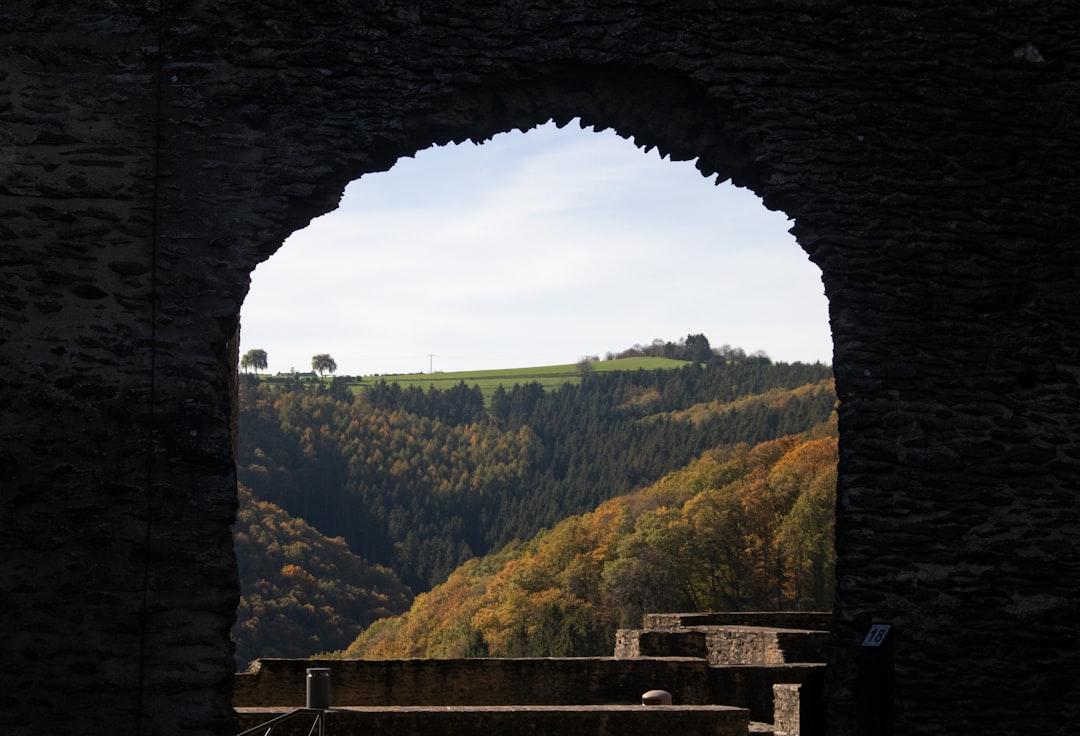 The Luxembourgish hillsides through the gate of a medieval castle