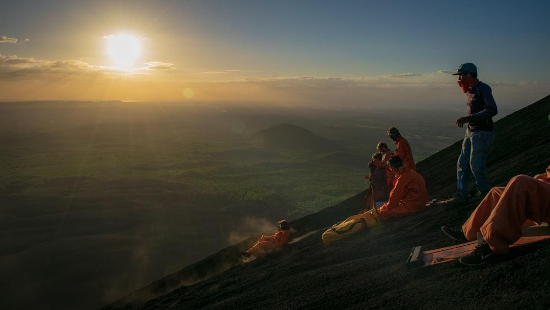 Volcano boarding down Volcan Cerro Negro, with the pacific ocean in the background