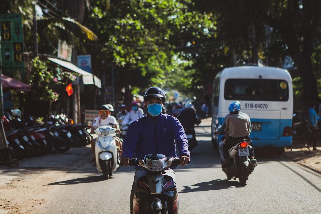 man in blue helmet riding on motorcycle during daytime