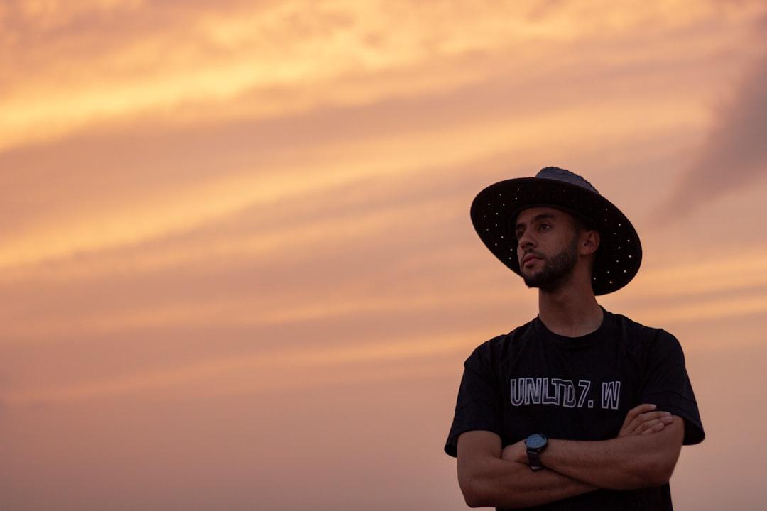 A man in a hat watching the sunset - algeria