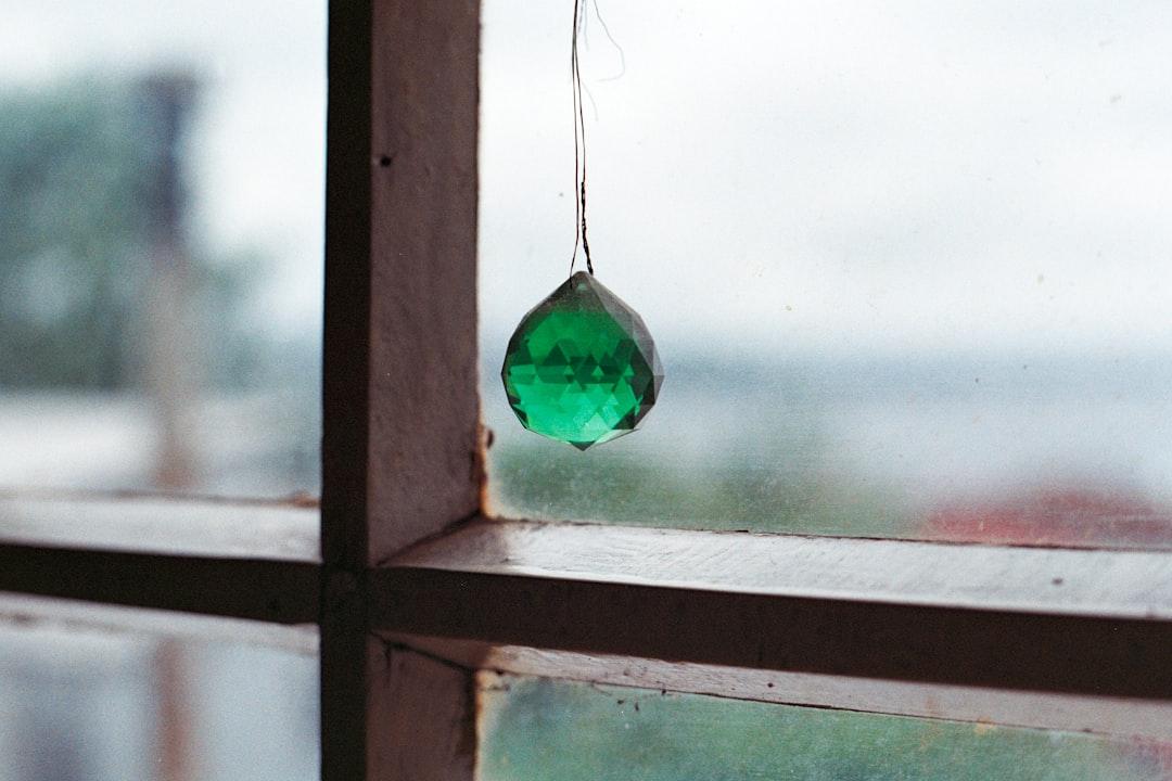 photo of hanging green stone near window