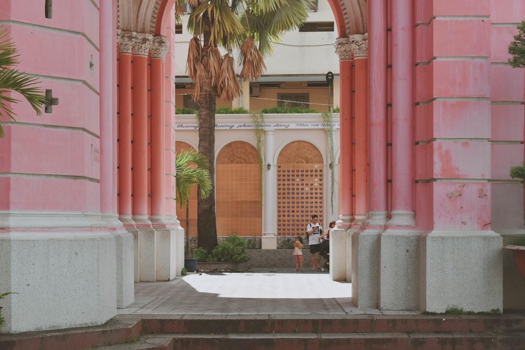 pink concrete building with arch walkway