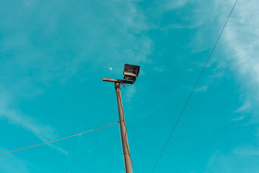 black and gray street light under blue sky