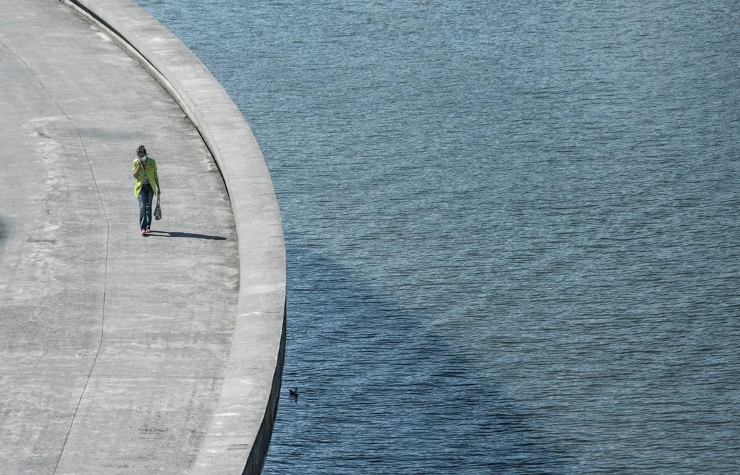 Woman walkingover a bridge in Bilbao.