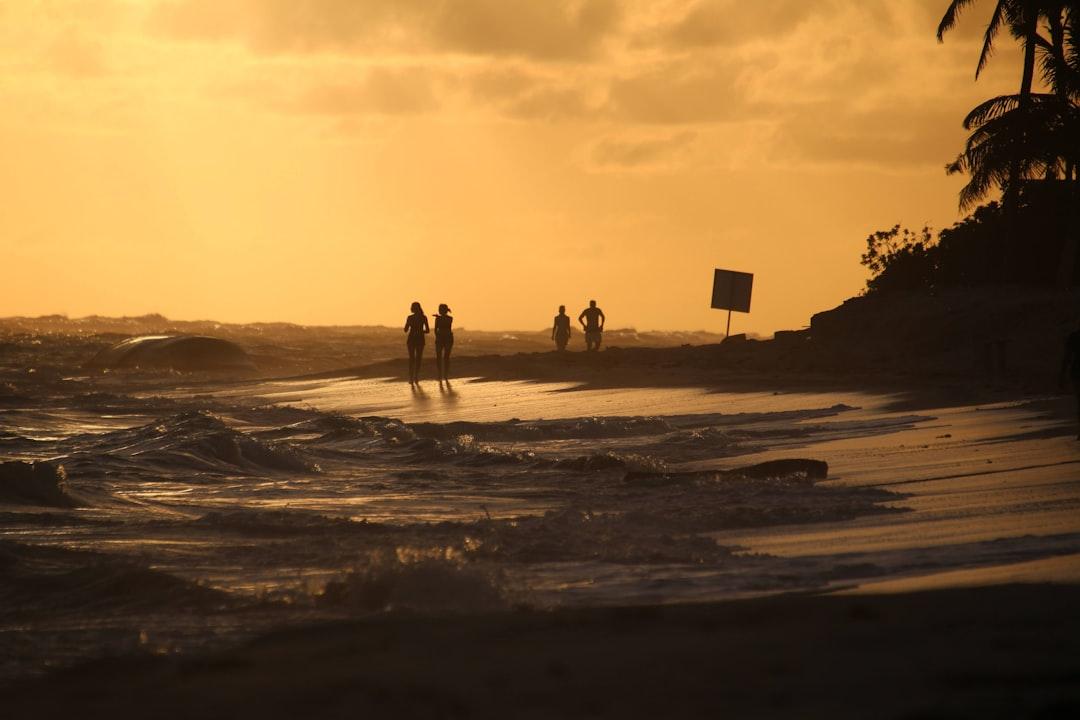 People enjoying the sunset at the shore of the atlantic ocean in the domenican republic